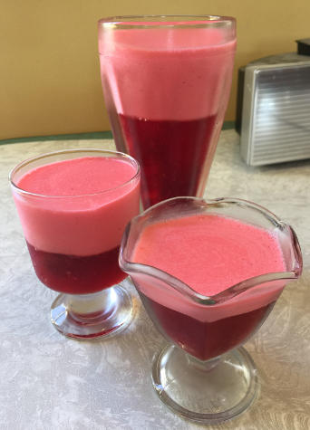 three glasses of different sizes with layered strawberry gelatin
