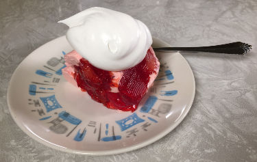 slice of Strawberries Romanov with Cool Whip topping
